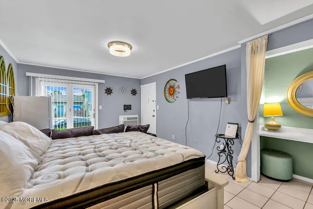 a bedroom with a bed and a flat screen tv