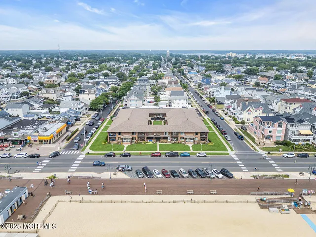 an aerial view of residential houses and car parked