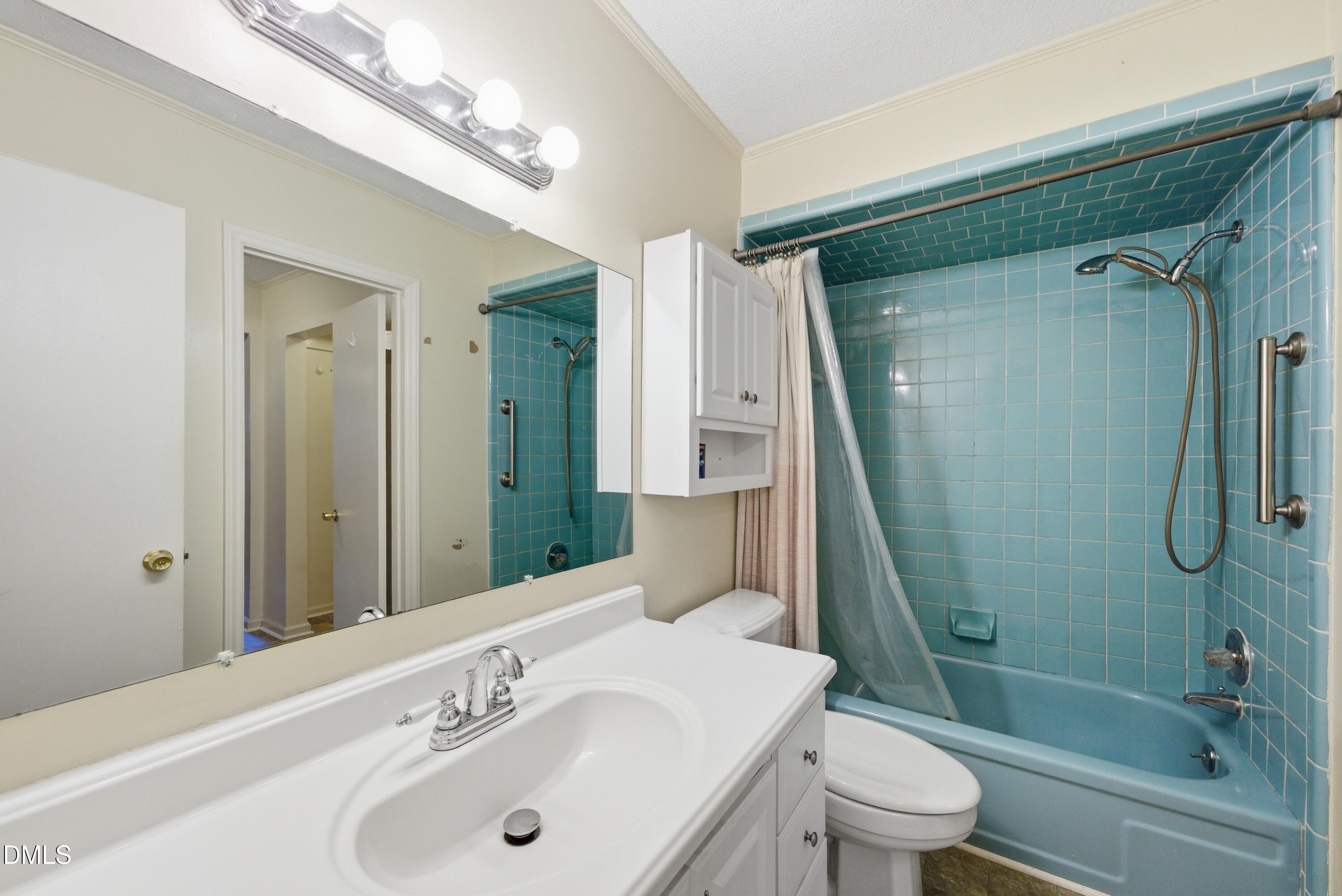 6355 New Market Way Raleigh, NC 27615 - Photo 25 of 30 a bathroom with a sink a toilet and shower