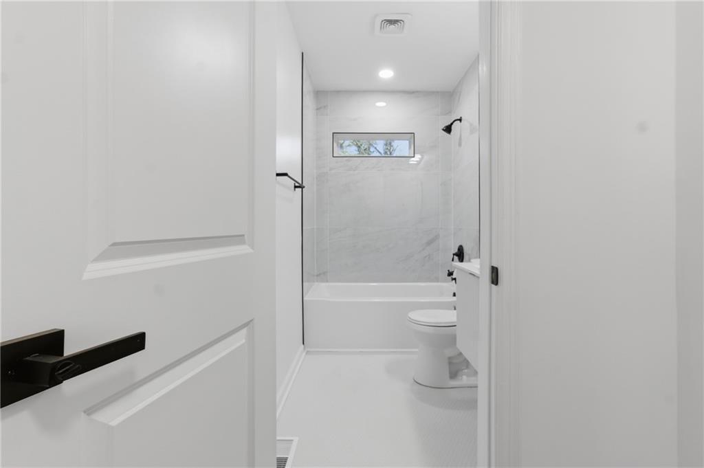 1410 Willis Mill Road Southwest Atlanta, GA 30311 - Photo 13 of 33 a bathroom with a shower a toilet and a sink