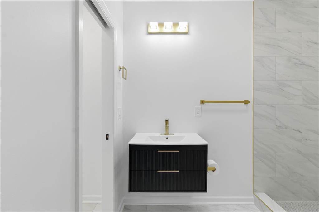 1410 Willis Mill Road Southwest Atlanta, GA 30311 - Photo 18 of 33 a bathroom with a sink and a mirror