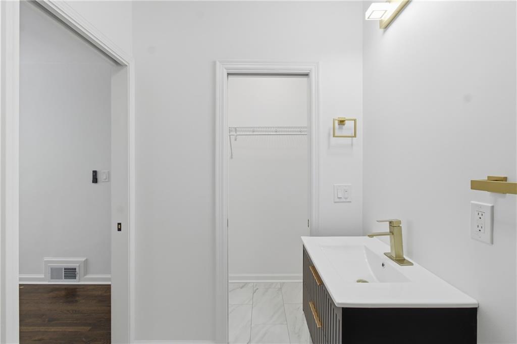 1410 Willis Mill Road Southwest Atlanta, GA 30311 - Photo 20 of 33 a bathroom with a sink and a mirror