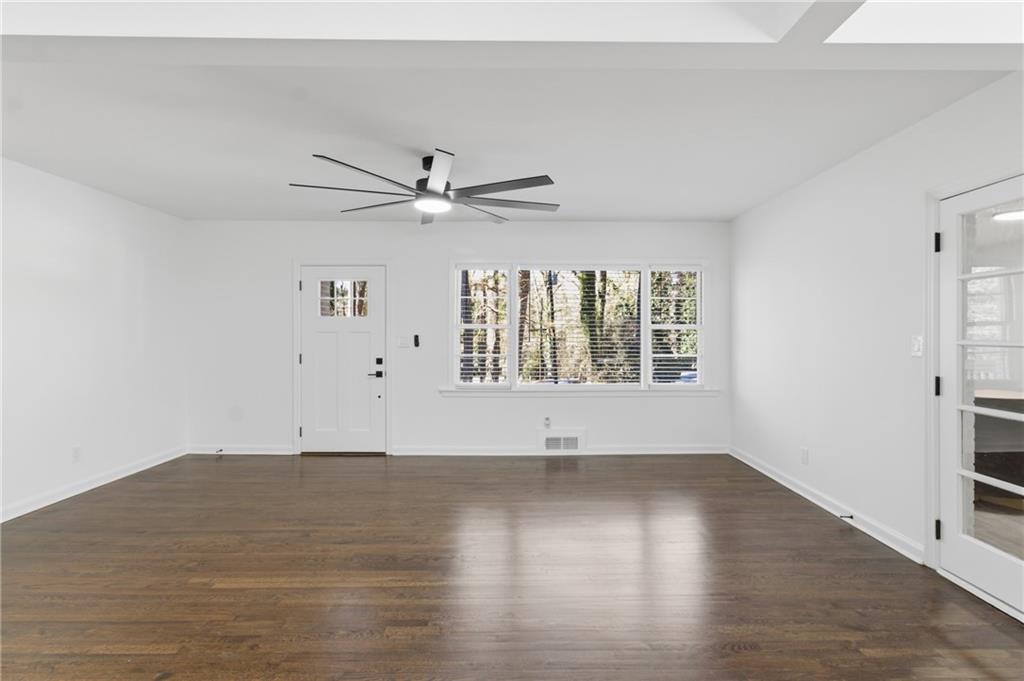 1410 Willis Mill Road Southwest Atlanta, GA 30311 - Photo 3 of 33 wooden floor in an empty room with a window