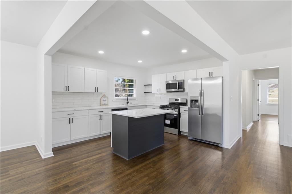 1410 Willis Mill Road Southwest Atlanta, GA 30311 - Photo 6 of 33 a kitchen with a refrigerator and white cabinets
