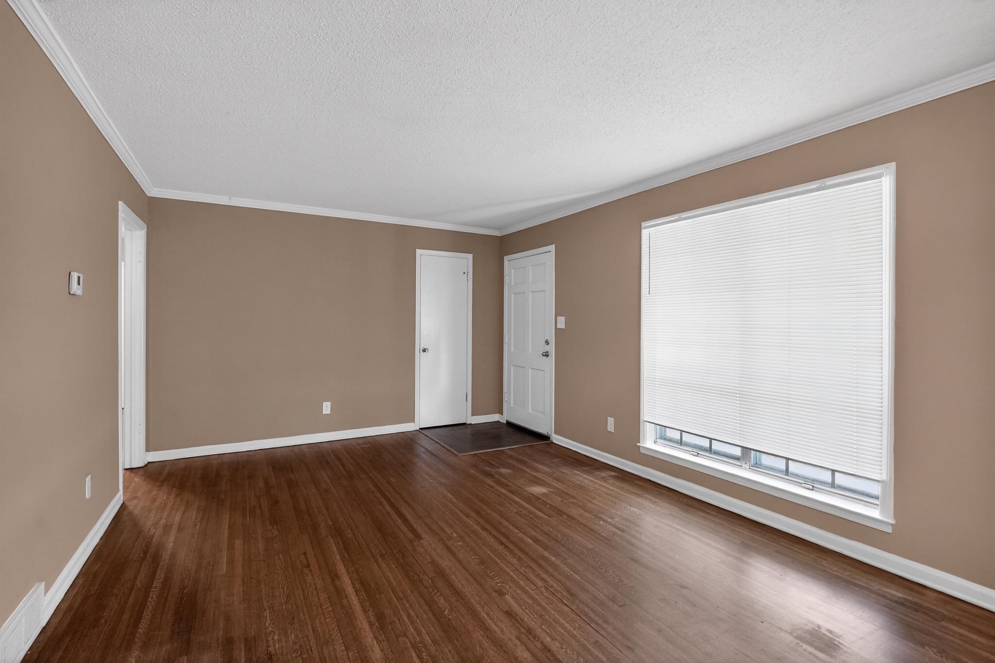 2015 East Holmes Road Memphis, TN 38116 - Photo 19 of 34 wooden floor in an empty room with a window