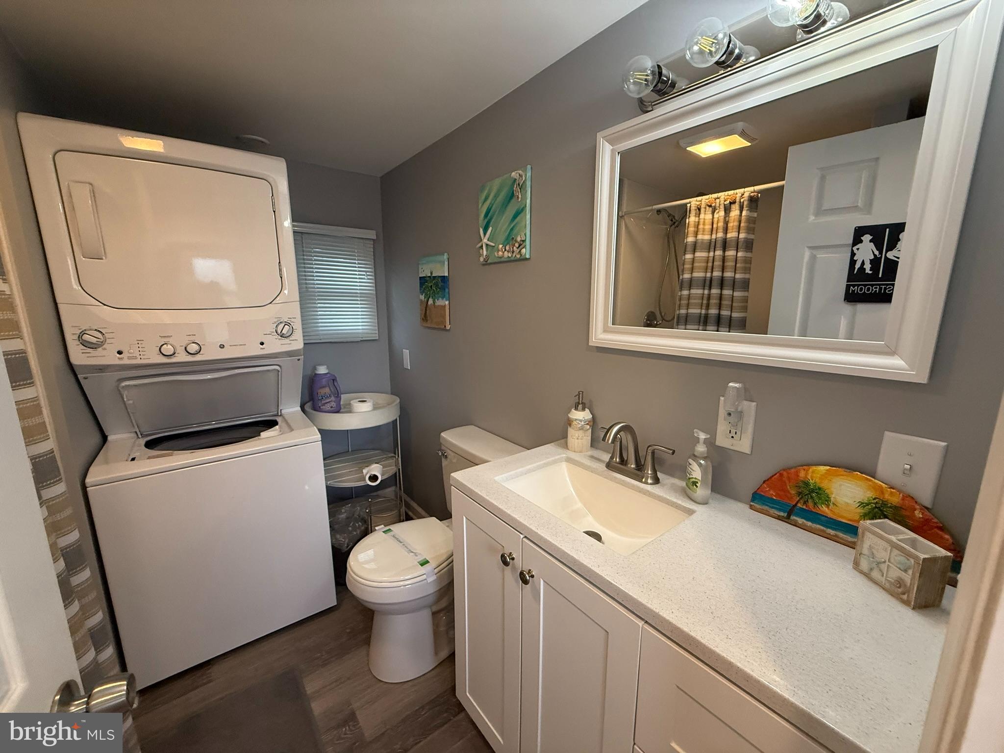 117 Clamshell Road Ocean City, MD 21842 - Photo 11 of 14 a bathroom with a toilet sink and mirror