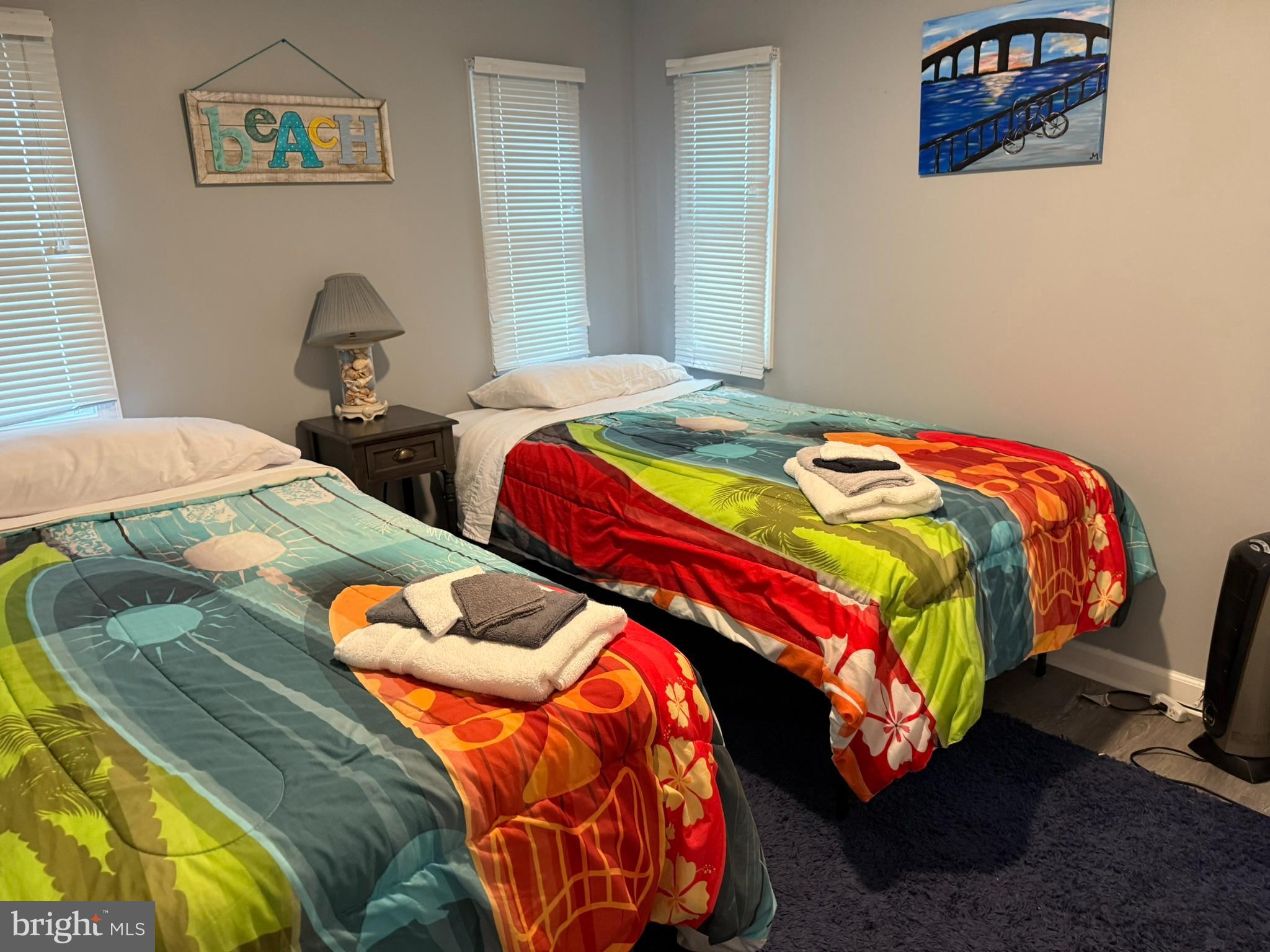 117 Clamshell Road Ocean City, MD 21842 - Photo 13 of 14 a bedroom with two beds and a painting on the wall