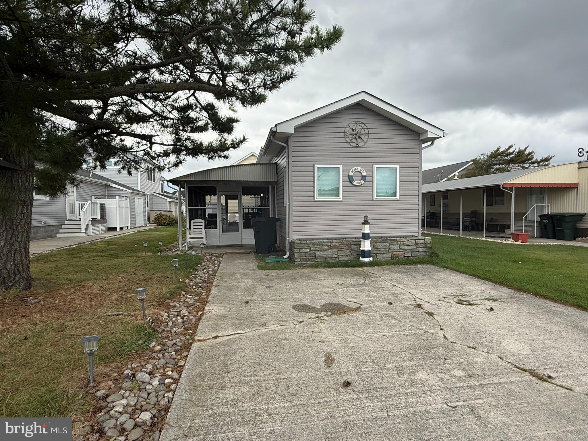 117 Clamshell Road Ocean City, MD 21842 - Photo 2 of 14 a front view of a house with garden