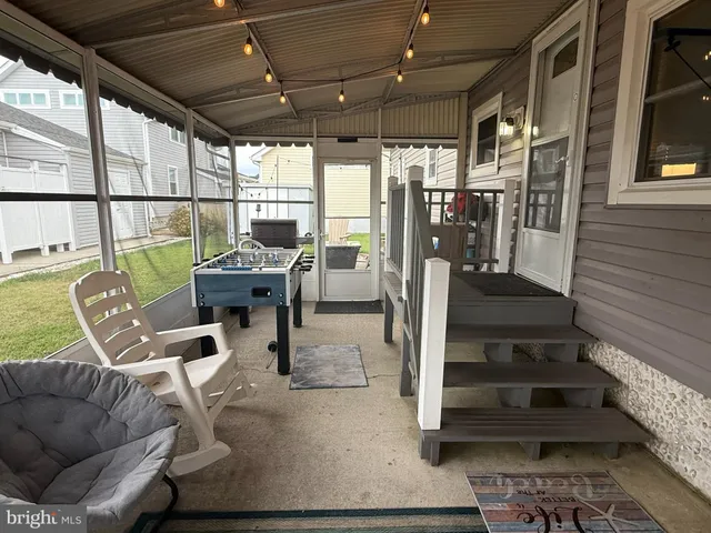 a view of a livingroom with furniture wooden floor and windows