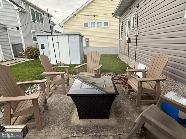 a view of a patio with table and chairs with wooden fence