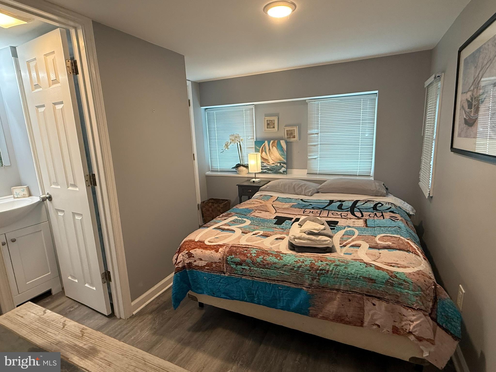 117 Clamshell Road Ocean City, MD 21842 - Photo 7 of 14 a bedroom with a bed and a mirror