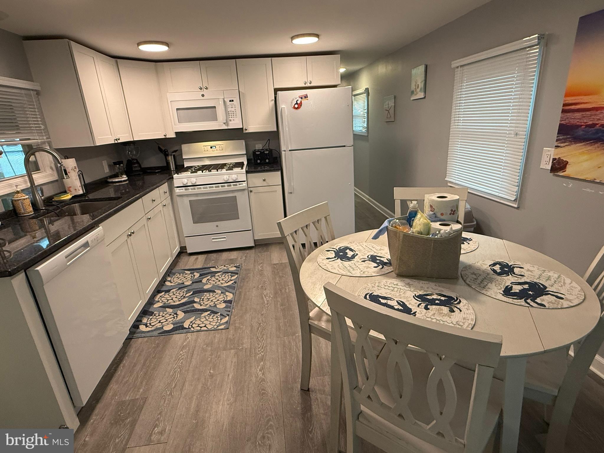 117 Clamshell Road Ocean City, MD 21842 - Photo 9 of 14 a kitchen with stainless steel appliances kitchen island granite countertop a sink a stove a refrigerator and island