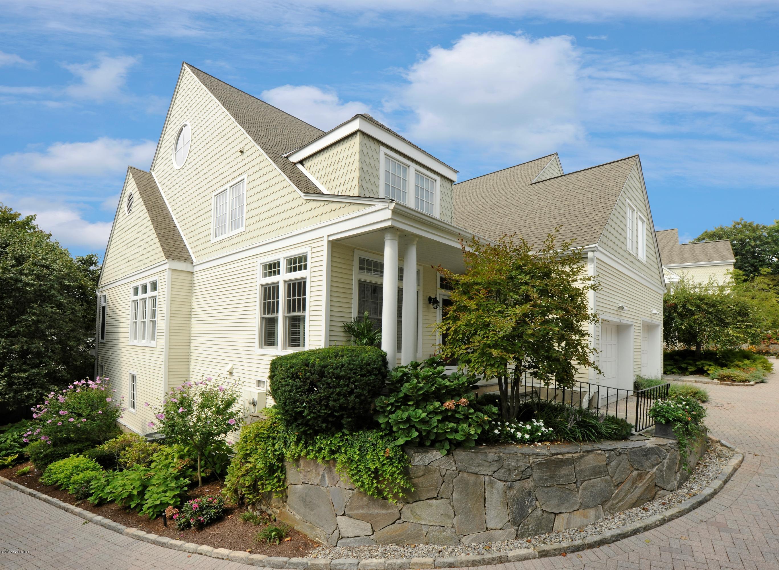 a view of a white house next to a yard