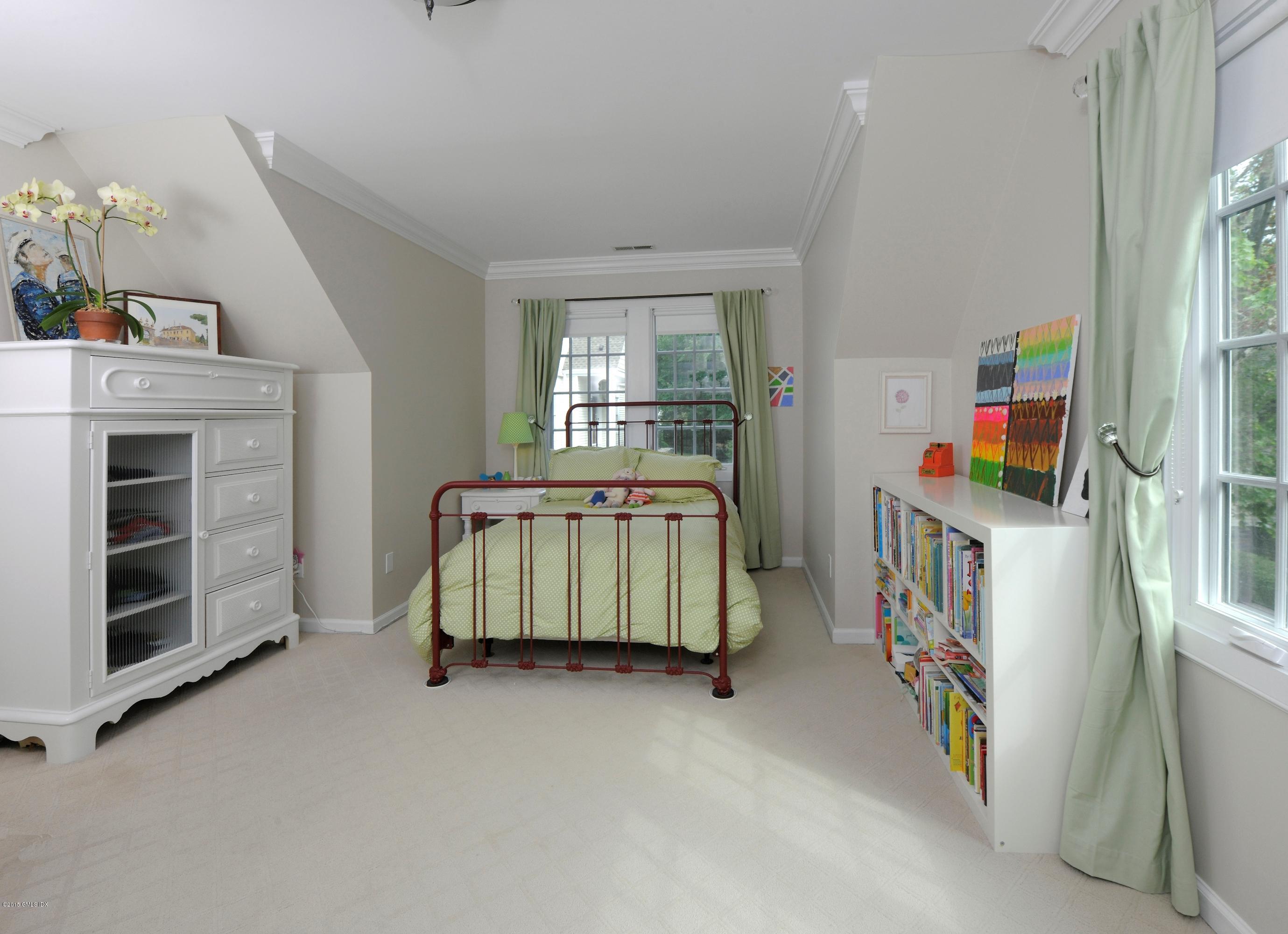 186 Field Point Road, Unit 4A Greenwich, CT 06830 - Photo 14 of 23 a room with furniture a baby crib and a window