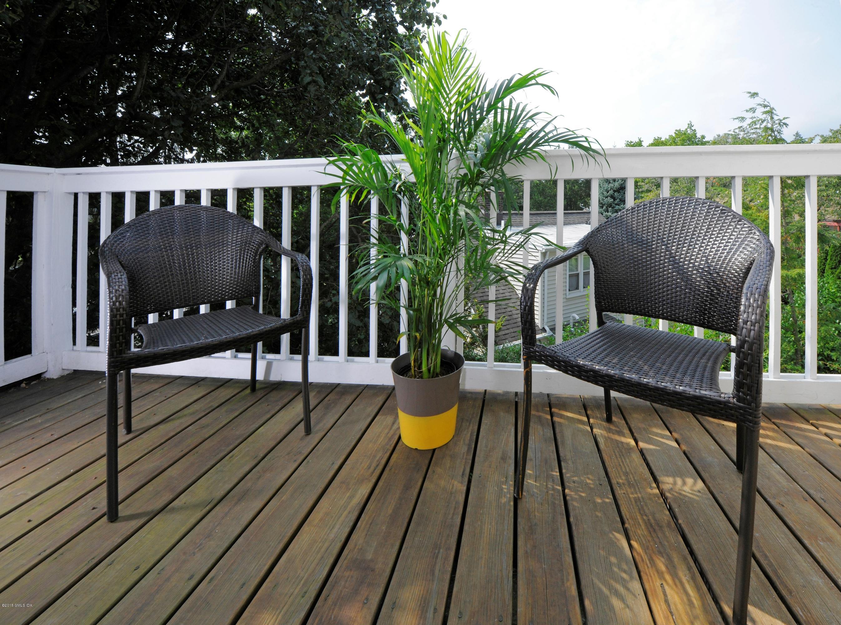 186 Field Point Road, Unit 4A Greenwich, CT 06830 - Photo 17 of 23 a view of balcony with wooden floor and outdoor seating