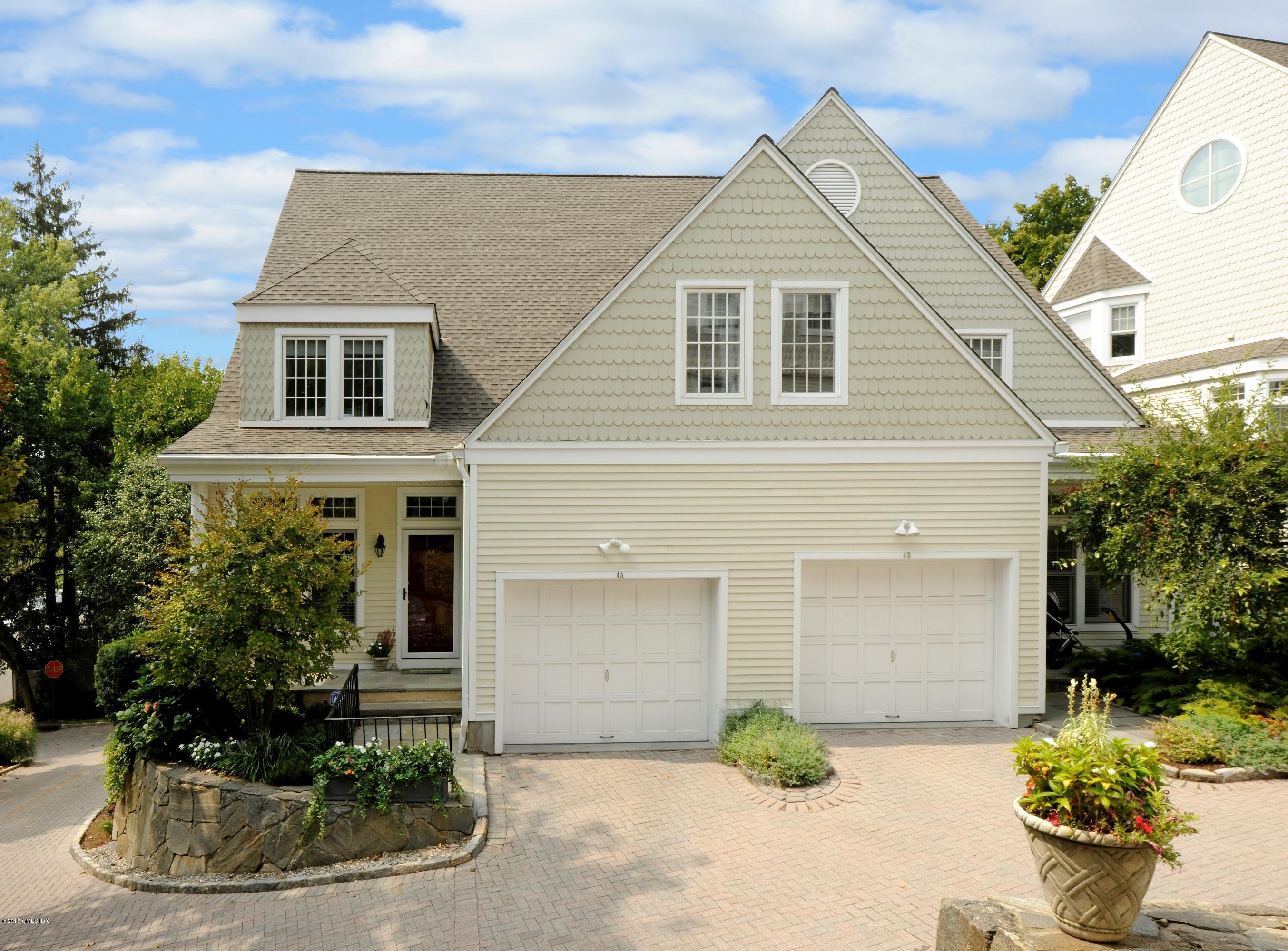 186 Field Point Road, Unit 4A Greenwich, CT 06830 - Photo 2 of 23 a front view of a house with potted plants