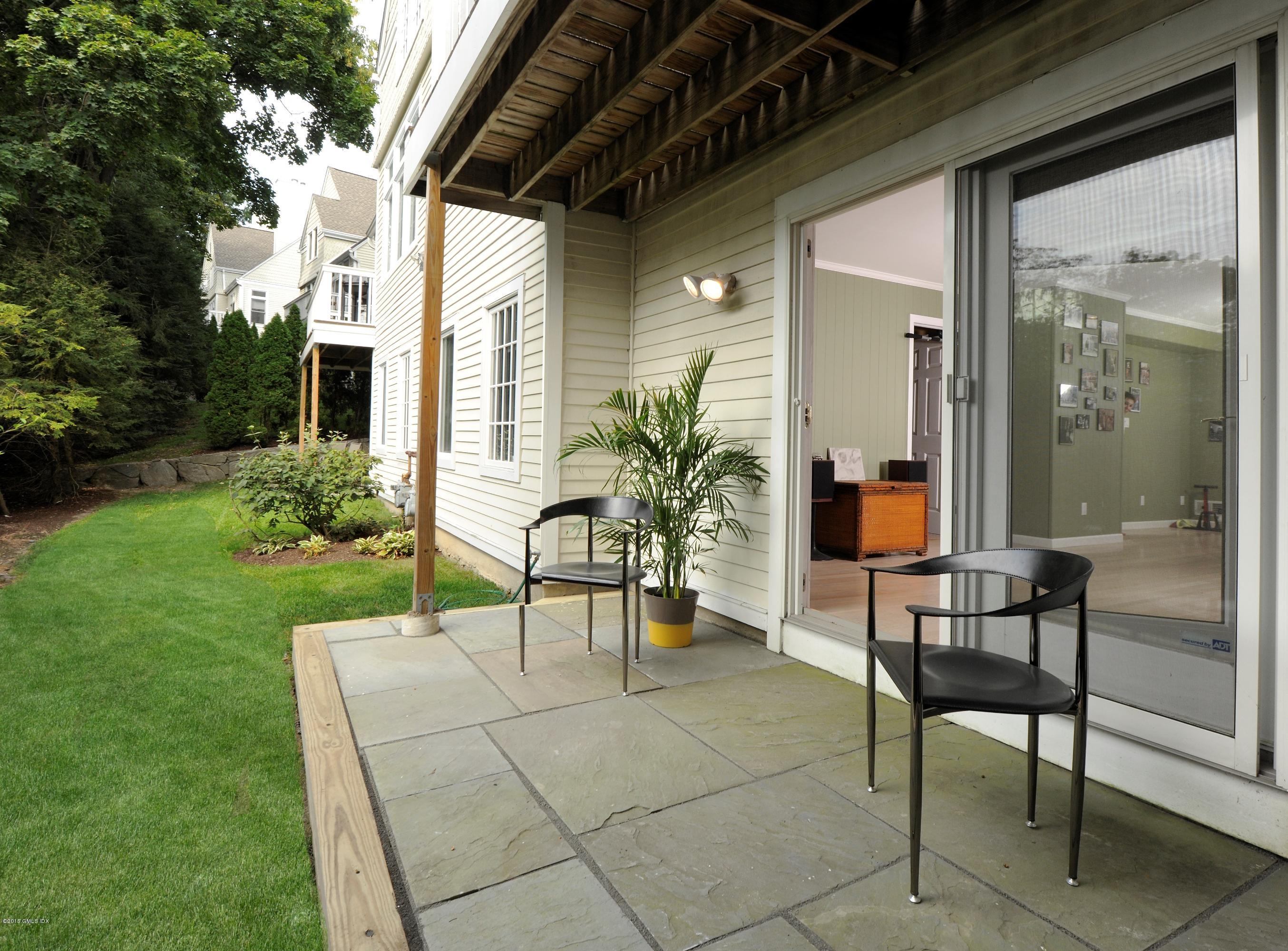 186 Field Point Road, Unit 4A Greenwich, CT 06830 - Photo 23 of 23 a view of a patio with a table and chairs and potted plants