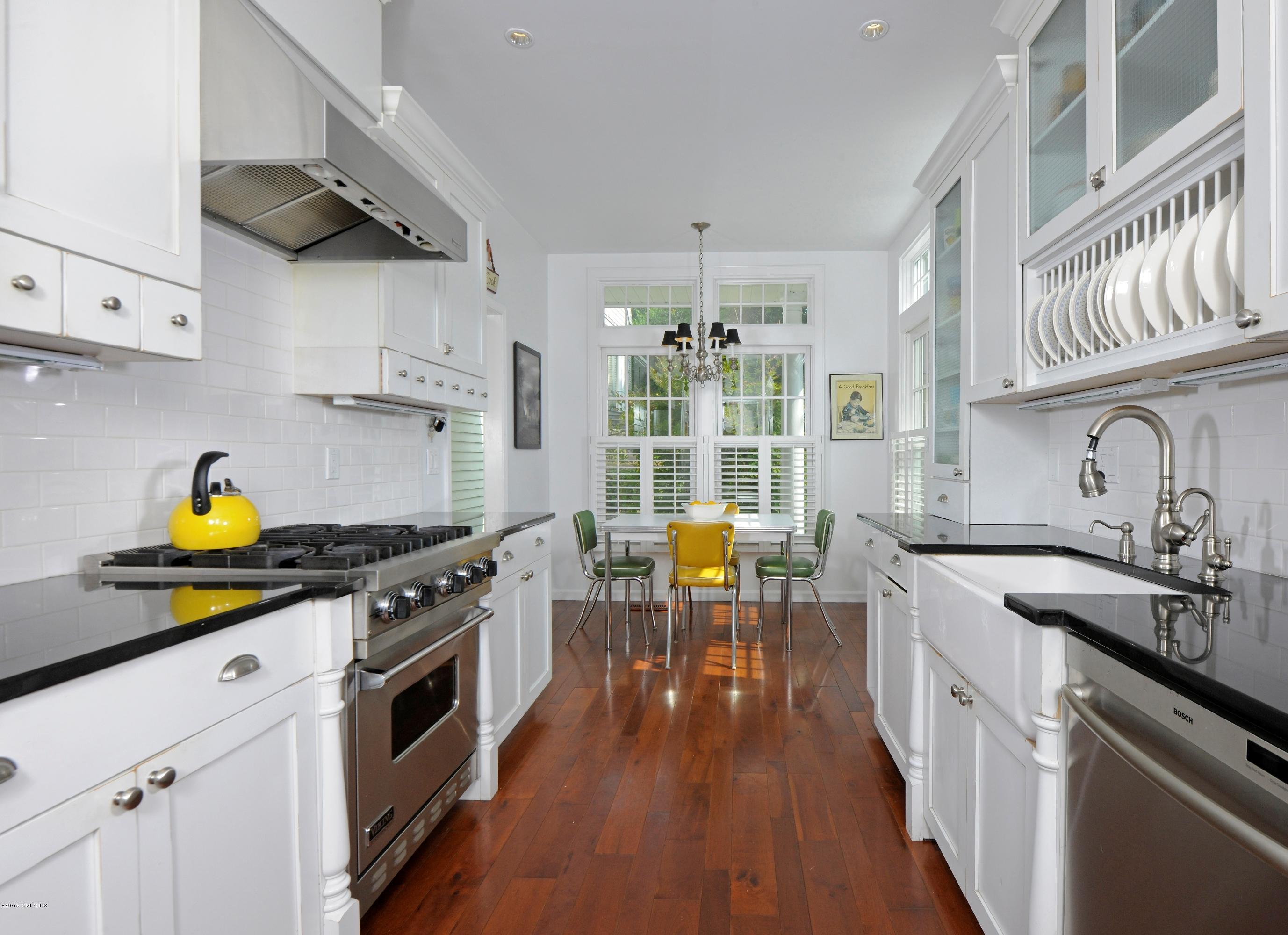 186 Field Point Road, Unit 4A Greenwich, CT 06830 - Photo 6 of 23 a kitchen with stainless steel appliances a stove a sink and cabinets