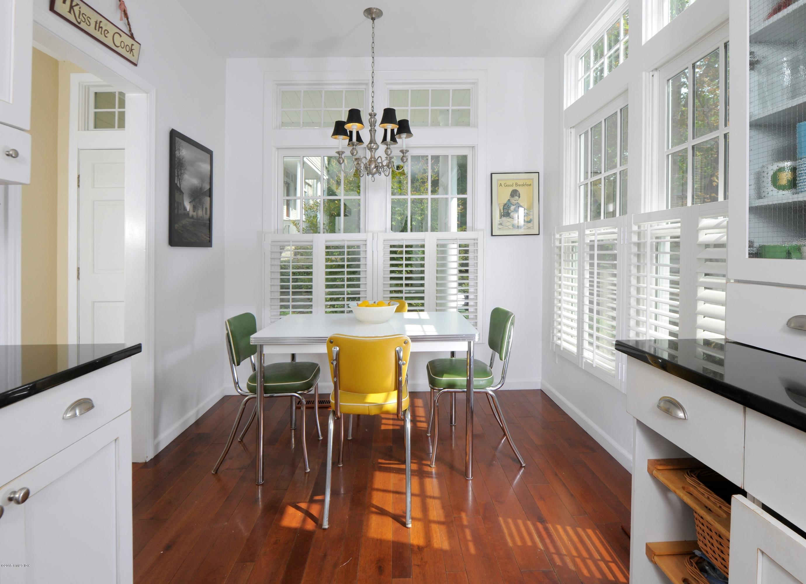 186 Field Point Road, Unit 4A Greenwich, CT 06830 - Photo 7 of 23 a view of a dining room with furniture and wooden floor