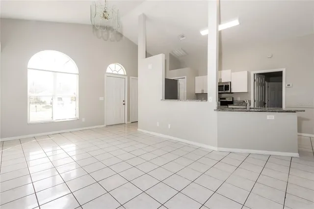 a view of a kitchen with kitchen island and natural light