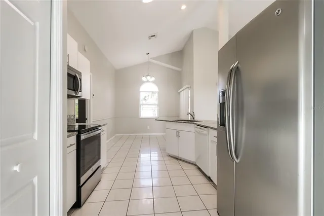 a kitchen with a refrigerator and a sink
