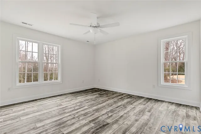 wooden floor in an empty room with a window
