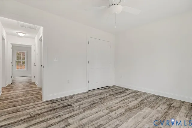 a view of room with wooden floor and fan