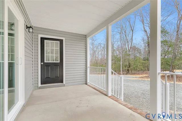 a view of a porch with wooden floor and backyard