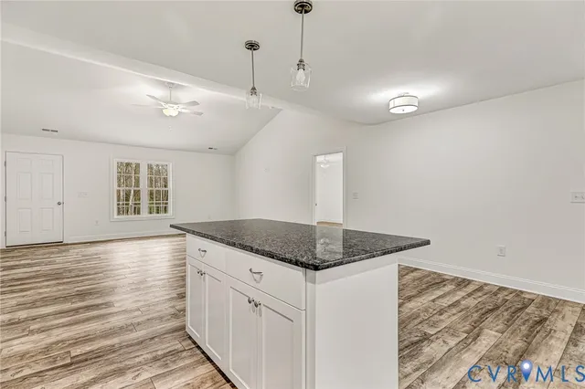 a kitchen with granite countertop a sink and a stove
