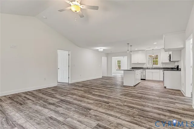 a view of kitchen with kitchen island stainless steel appliances refrigerator stove and cabinets