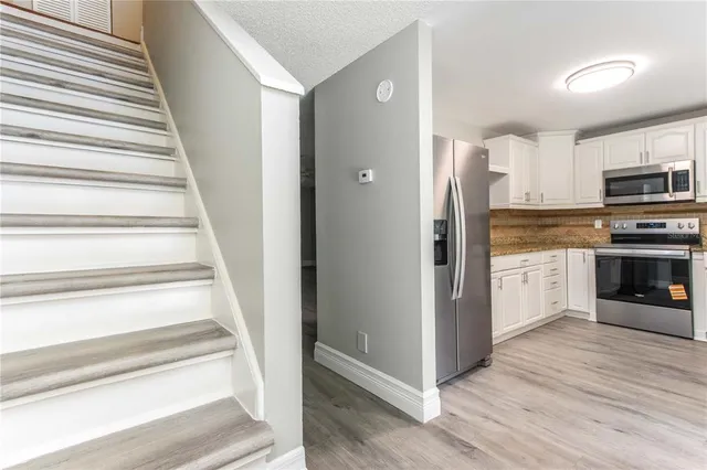 a view of an entryway with wooden floor