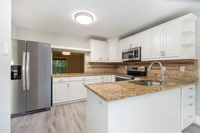 a view of entryway with wooden floor and door