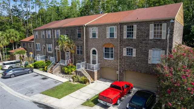 an outdoor space with seating area and trees in the background