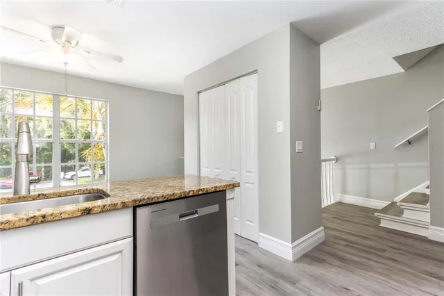 a bathroom with a granite countertop toilet and a sink