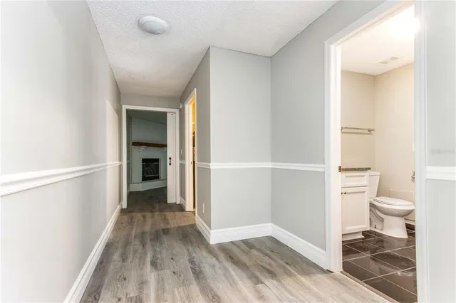 a view of a hallway with wooden floor and entryway