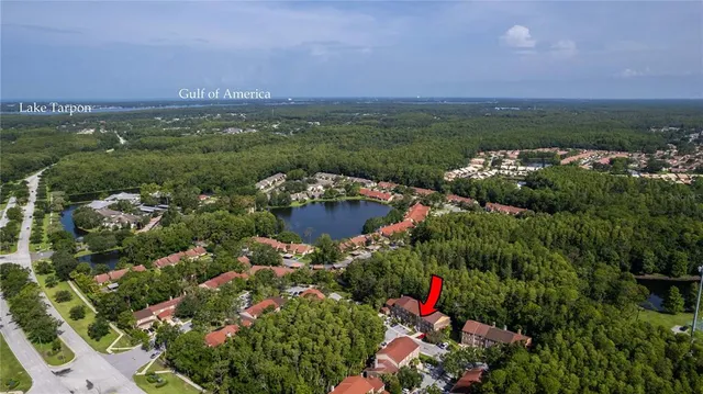 a view of a brick house with many windows next to a yard