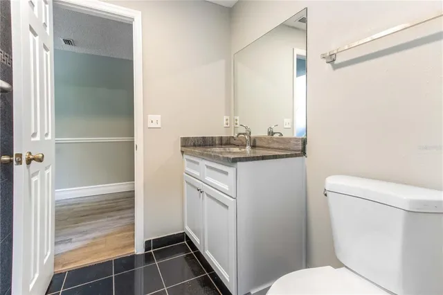 an empty room with a window and wooden floor