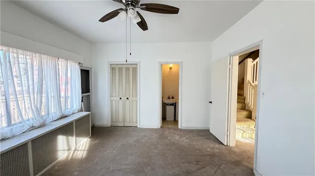 a view of hallway with chandelier and a window