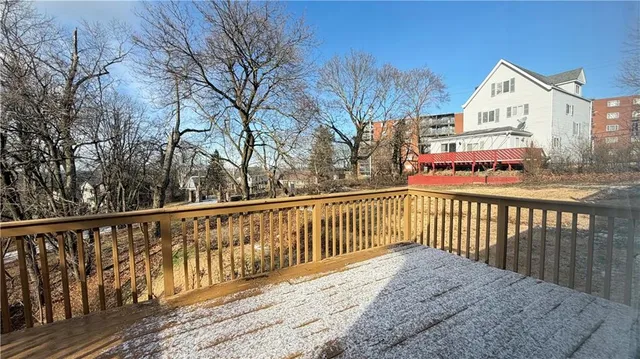a balcony with wooden floor and fence