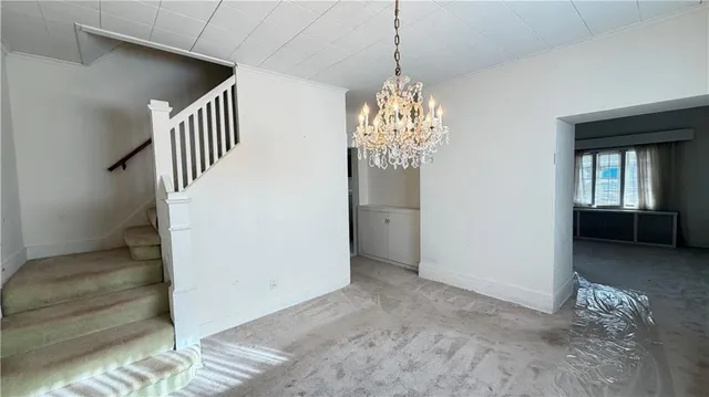 a view interior of a house with stairs and chandelier