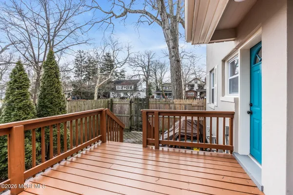 a view of balcony with wooden floor and outdoor seating