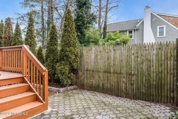 a view of a house with a wooden fence