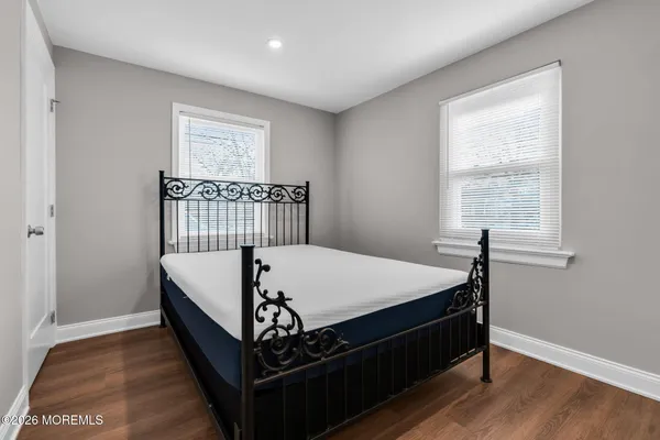 a bed sitting in a bedroom next to a window