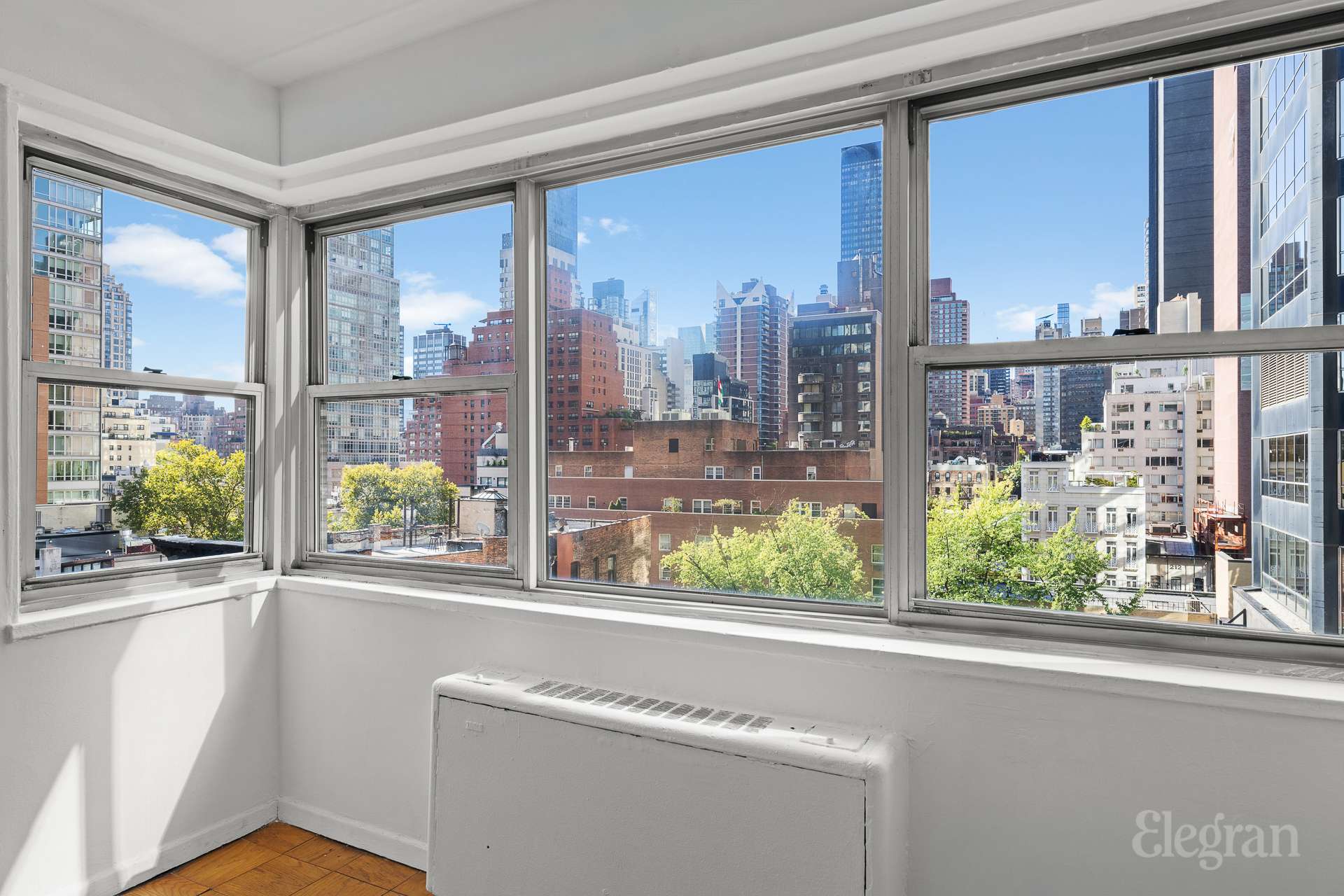 211 East 53rd Street, Unit 10F Manhattan, NY 10022 - Photo 2 of 8 a view of a city from a living room