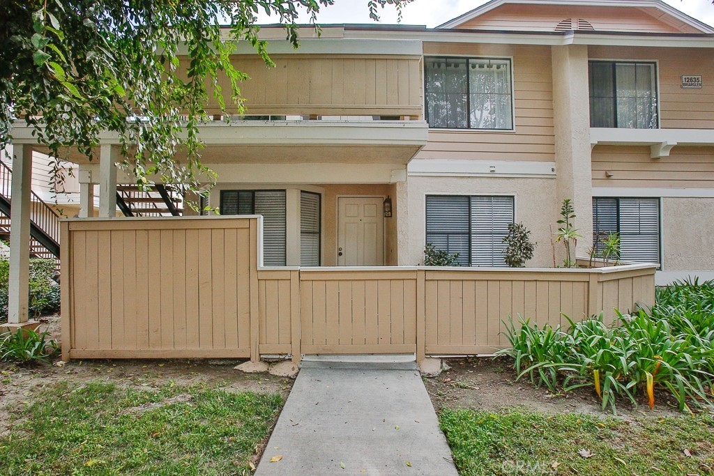 a view of a house with a small yard and plants