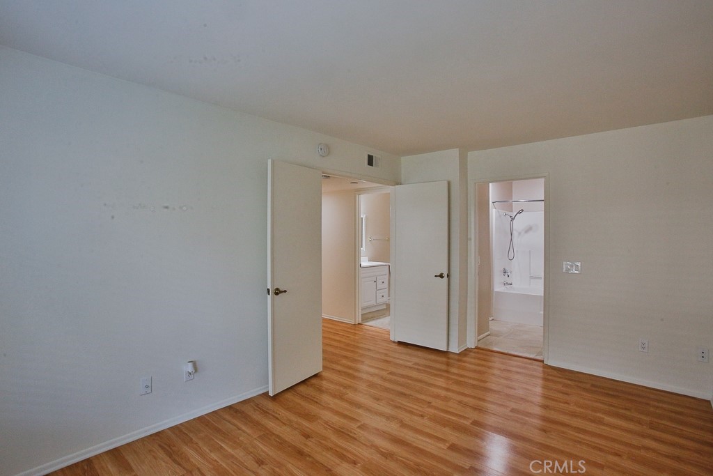 12635 Briarglen Loop, Unit G Stanton, CA 90680 - Photo 11 of 19 a view of a room with wooden floor and white walls