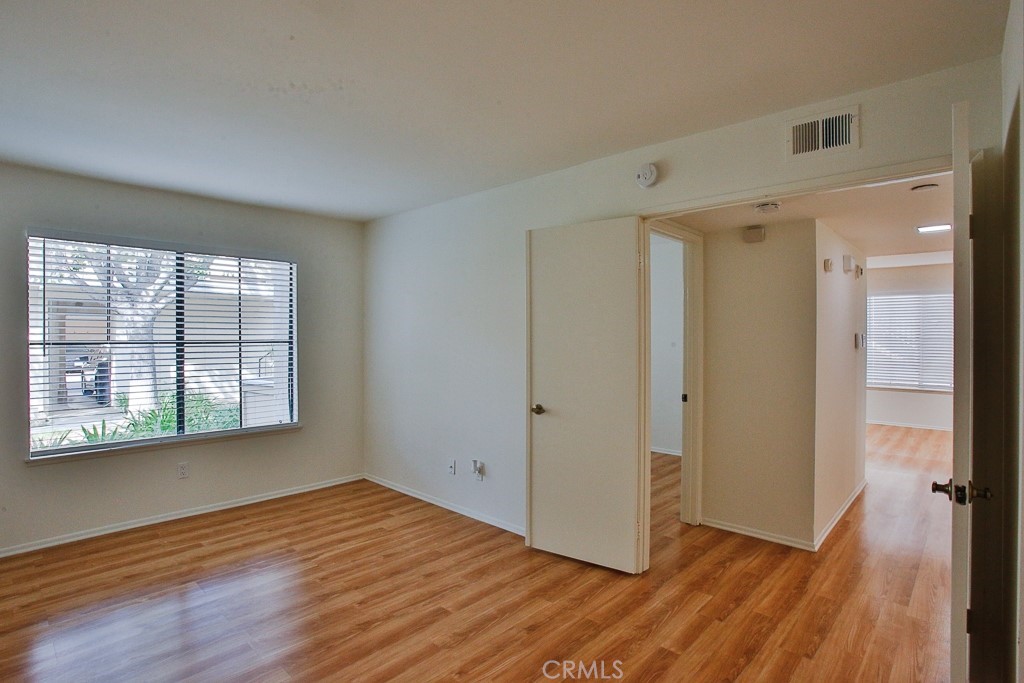 12635 Briarglen Loop, Unit G Stanton, CA 90680 - Photo 12 of 19 a view of empty room with wooden floor and fan