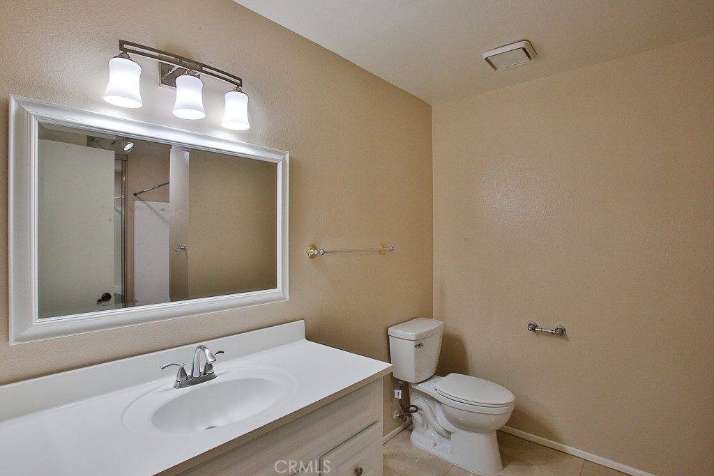 12635 Briarglen Loop, Unit G Stanton, CA 90680 - Photo 15 of 19 a bathroom with a sink vanity mirror and toilet
