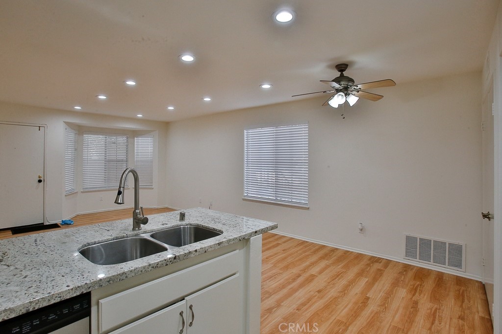 12635 Briarglen Loop, Unit G Stanton, CA 90680 - Photo 17 of 19 a kitchen with a sink and chandelier