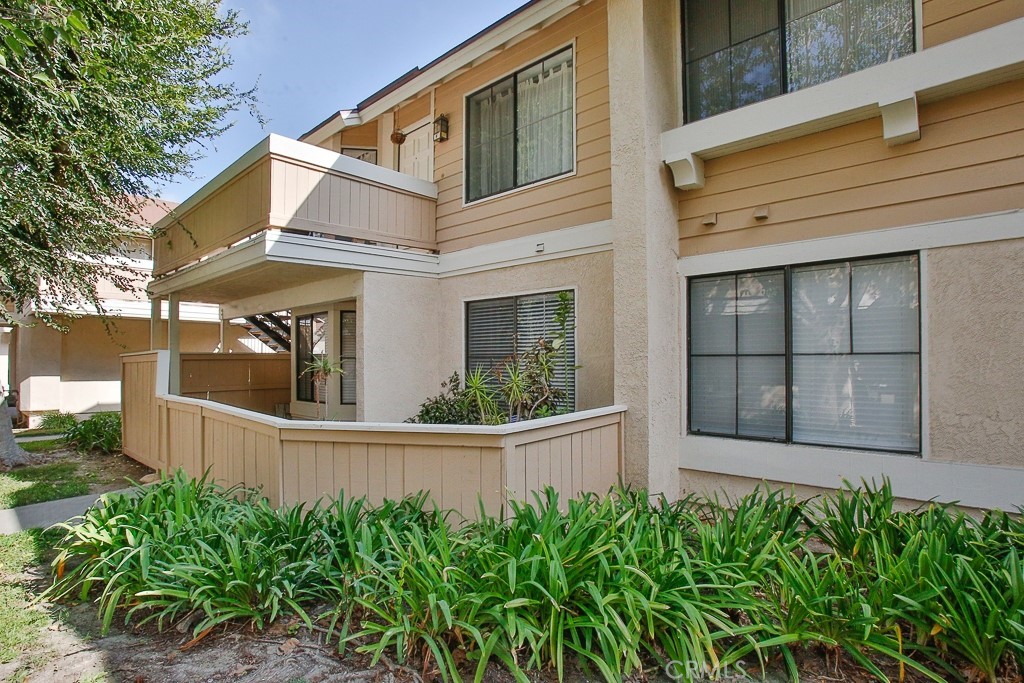 12635 Briarglen Loop, Unit G Stanton, CA 90680 - Photo 4 of 19 front view of a house with a small yard
